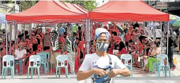  ?? — NIÑO JESUS ORBETA ?? ‘AYUDA’ QUEUE Residents endure the heat outside a barangay hall in Quezon City while waiting for their turn to receive cash aid from the government.