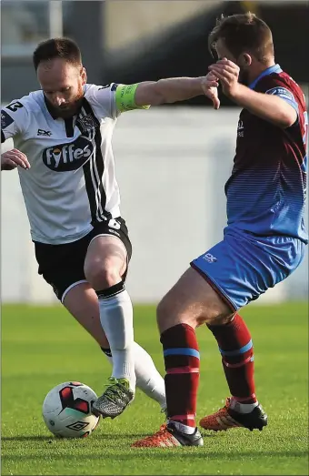  ??  ?? Ryan McEvoy of Drogheda United challenges Dundalk’s Stephen O’Donnell on Friday night.