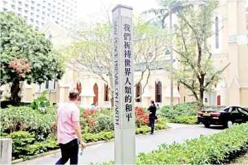  ?? — Reuters photos ?? A peace pole is displayed outside a church in Hong Kong, China.