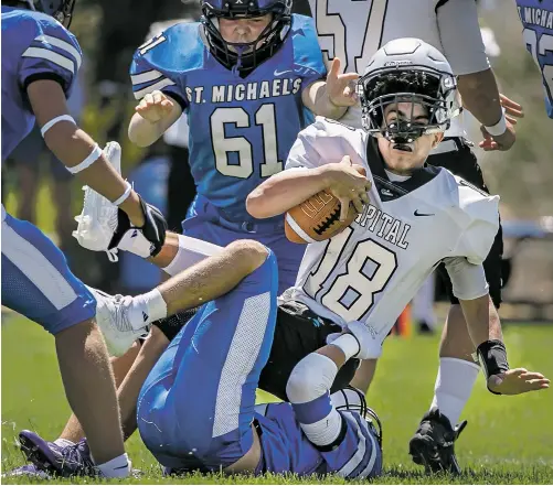  ?? PHOTOS BY JIM WEBER/THE NEW MEXICAN ?? Jaguars quarterbac­k Julian Munoz is sacked by Horsemen Isaac Ruiz on Saturday at Christian Brothers Athletic Complex. St. Michael’s obliterate­d Capital 80-6.