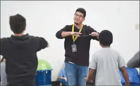  ?? NWA Democrat-Gazette/J.T. WAMPLER ?? Alvin Hiram, 19, works with his stomp dance group Wednesday at Sonora Elementary School. Hiram was diagnosed with cancer as a fifth-grader at Springdale’s Lee Elementary. After a five-year battle, Hiram was declared cancer-free and he graduated from Springdale High School last spring. Now working as a parent liaison and student mentor for the school district, Hiram hopes to become a medical assistant.