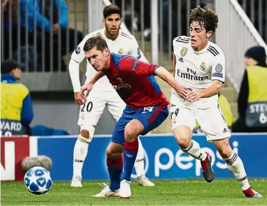  ?? — AP ?? Out of my way: Real Madrid defender Alvaro Odriozola (right) vying for the ball with CSKA Moscow defender Kirill Nababkin during the Champions League Group G match at the Luzhniki Stadium in Moscow on Tuesday.