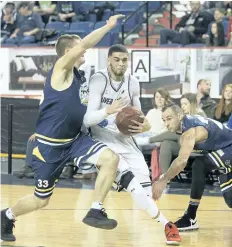  ?? BOB TYMCZYSZYN/ STANDARD STAFF ?? Niagara River Lions Guillaume Boucard ( 9) drives against St. John's Edge players in National Basketball League of Canada action Saturday at Meridian Centre in St. Catharines.