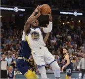  ?? BRANDON DILL — THE ASSOCIATED PRESS ?? Golden State Warriors forward Jonathan Kuminga (00) shoots against Memphis Grizzlies guard Ziaire Williams during the first half of Game 2of a second-round NBA basketball playoff series Tuesday in Memphis, Tenn.