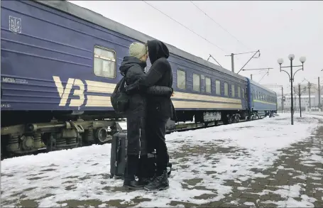  ?? Carolyn Cole Los Angeles Times ?? IN LVIV, Karina Gudova says goodbye to boyfriend Vitaliy Lomnytskyi, who was called up by Ukraine’s military. She will go to Germany.