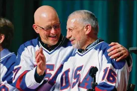  ?? MIKE GROLL / AP 2015 ?? 1980 USA hockey teammates Jack O’Callahan (left) and Mark Pavelich talk during a “Relive the Miracle” reunion at Herb Brooks Arena in Lake Placid, N.Y., on Feb. 21, 2015. Pavelich, who mostly shunned the spotlight after his playing days were over, had two assists in Team USA’s 4-3 victory over the Soviet Union on Feb. 22, 1980, including one on Mike Eruzione’s game-winning goal. Some old teammates and family members in recent years had begun to wonder if Pavelich was suffering from mental illness brought on by blows to the head during his playing days.