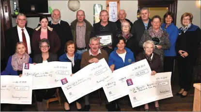  ?? Photo by Michelle Cooper Galvin ?? Brendan Ferris Organiser Threshing Cancer (seated) presenting the €32,000 proceeds from the Threshing Cancer day to (from left) Mairead Enright Oncology Unit UHK €2000, Breda Dyland Kerry Cork Health Link Bus and Kerry Cancer Support Group €3000, Marian Barnes Recovery Haven €9000, Michelle Jones Kerry Hospice €16,000, Sr Helena St Joseph’s Home Killorglin €2000 with (back from left) Dermot Crowley, Trish Kelly, Chris Robbins, Randall Joy, Teddy Clifford, Jim Clifford, Mike O’Shea, Kathleen Brosnan, Kay Woods and maureen O’Brien at Galvin’s Bar, Beaufort on Friday.