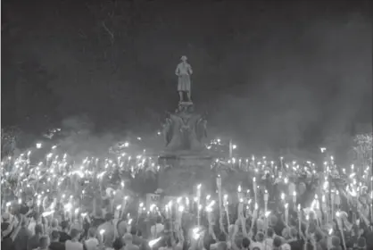  ?? NEW YORK TIMES FILE PHOTO ?? White supremacis­ts rally on the University of Virginia campus Aug. 11. Open debate and dialogue in a university lecture hall is a far better scenario than Charlottes­ville, Kevin Gosine writes.