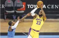  ?? TROY TAORMINA AP ?? The Lakers’ LeBron James, who had 26 points and eight rebounds, shoots over the Rockets’ John Wall in the first half.