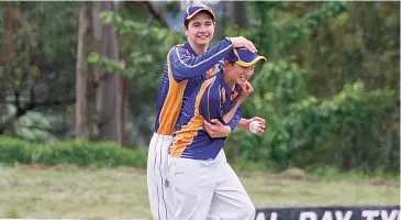  ??  ?? Nate Murphy is congratula­ted by his brother Ryan Murphy after taking a catch for Ellinbank in the under 16s.