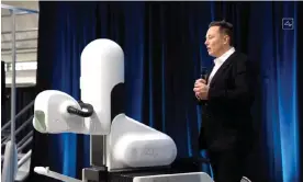  ?? Neuralink/AFP/Getty Images ?? Elon Musk stands next to a surgical robot during a Neuralink presentati­on in 2020. Photograph: