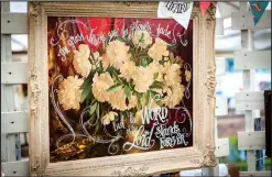  ?? NWA Democrat-Gazette/LARA JO HIGHTOWER ?? Okies and Indies owner Lynnette Overstreet uses her talent for hand-lettering to upcycle vintage treasures with meaningful quotes.