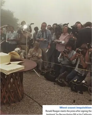  ??  ?? West coast inquisitio­n
Ronald Reagan meets the press after signing the landmark Tax Reconcilia­tion Bill at his California home, 1981. Slashing taxes was one of Reagan's signature economic policies