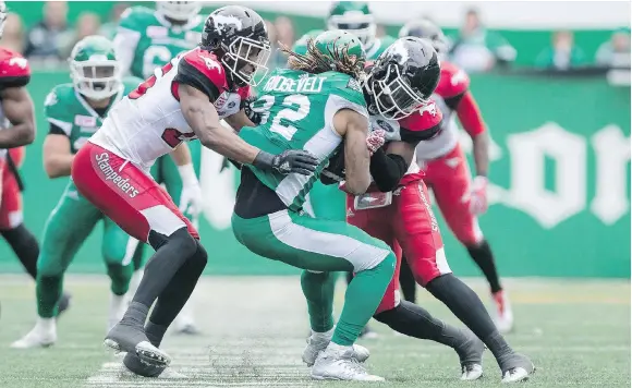  ?? MICHAEL BELL ?? Saskatchew­an receiver Naaman Roosevelt may not be available Friday after this helmet-on-helmet hit Sunday by Calgary’s Tunde Adeleke, right.