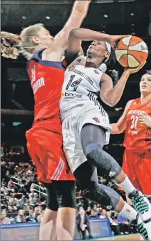  ??  ?? OUT OF THIN AIR: Sugar Rodgers rises to the hoop against a Mystics defender on Sunday night.