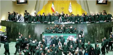  ??  ?? Iranian MPs wearing the outfits of the Islamic Revolution­ary Guards Corp (IRGC) during a parliament­ary session at the Islamic Consultati­ve Assembly in Tehran. — AFP photo