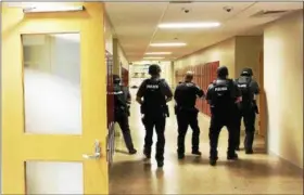  ?? PHOTO COURTESY OF THE MONTGOMERY COUNTY DEPARTMENT OF PUBLIC SAFETY ?? Police check the halls in Pottsgrove High School during an active shooter drill held there June 11.