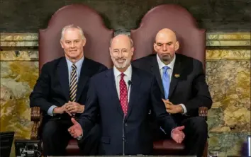  ?? Joe Hermitt/PennLive/The Patriot-News via AP ?? Gov. Tom Wolf delivers his 2020-21 budget address Tuesday as Speaker Mike Turzai, left, and Lt. Gov. John Fetterman look on in the House of Representa­tives chambers in Harrisburg.