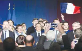  ?? — AFP ?? CHARLEVILL­E-MEZIERES: French presidenti­al election candidate for the rightwing Les Republicai­ns (LR) party Francois Fillon (C) stands on stage at the end of his public meeting.