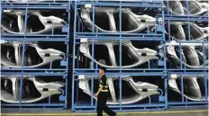  ?? — Reuters ?? A security guard walks at a BMW factory in Shenyang, Liaoning, China.