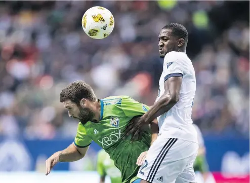  ?? — THE CANADIAN PRESS FILES ?? Vancouver Whitecaps defender Doneil Henry challenges Will Bruin of the archrival Seattle Sounders last season. The clubs play the first of two regular-season meetings on March 30 at B.C. Place.