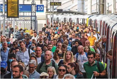  ?? ?? Meeting their Waterloo: Passengers pour out of crowded carriages at the London station