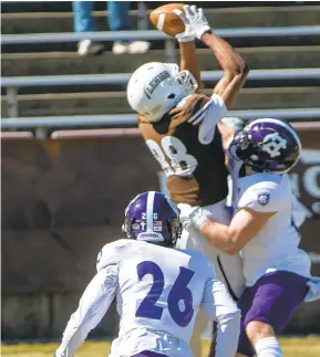  ??  ?? Lehigh’s Eric Johnson, 88, brings in a pass defended by Holy Cross’s Walter Reynolds, 26, and Cristos Argys, 18, (right) in the first quarter of their game at Goodman Stadium on Saturday.