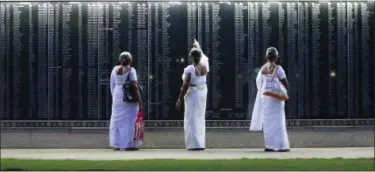  ?? ERANGA JAYAWARDEN­A — THE ASSOCIATED PRESS ?? Mothers of fallen Sri Lankan government soldiers check for the name of their sons engraved on the national war heroes memorial in Colombo, Sri Lanka, Friday. Sri Lanka marked the eighth anniversar­y of the end of its bloody civil war on Friday with much...