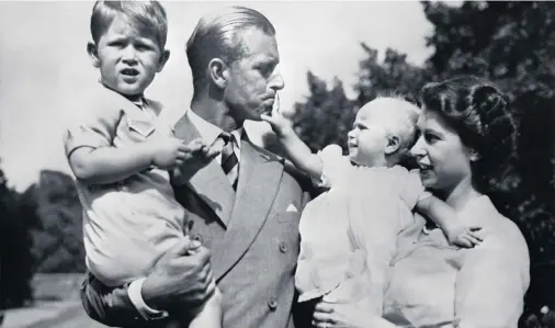  ??  ?? Young parents with Prince Charles and his sister Princess Anne