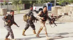  ?? — AFP ?? KIRKUK: Iraqi Kurdish security forces patrol a street in the southern suburbs of this city yesterday.