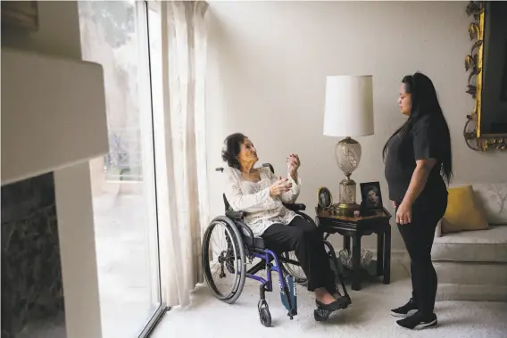  ?? Gabrielle Lurie / The Chronicle ?? Lee Savasta talks with her caretaker, Annabelle Tadina. Savasta says “healthy food” like steak, pork chops, spaghetti and a little wine has helped her live to 100.