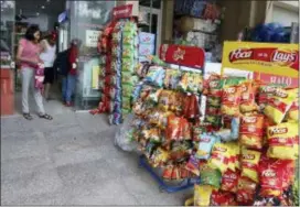  ?? MINH HOANG — THE ASSOCIATED PRESS ?? People shop at a well-stocked convenient in Hanoi, Vietnam, Thursday. Vietnam, the location of President Donald Trump’s next meeting with North Korean leader Kim Jong Un, has come along way since the Us abandoned its war against communist North Vietnam in the 1970s.