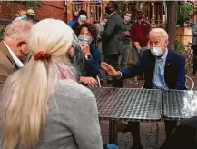  ?? Jim Watson / AFP via Getty Images ?? Democratic presidenti­al candidate Joe Biden talks to people at Amazing Grace Cafe and Grocer in Duluth, Minn.