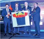  ??  ?? From left: M.T.M.Naufal (Managing Director) and M.T.M. Nawushad (Chairman of Kandurata Umbrellas) handing over the 2019 rugby sponsorshi­p to the Principal of Trinity College, Andrew Fowler-Watt and Chairman of Trinity College Scrummage Siva Subramania­m