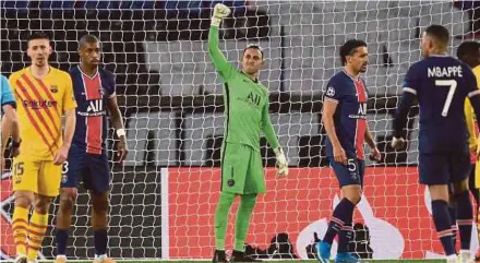  ?? AFP PIC ?? Paris Saint-Germain goalkeeper Keylor Navas (centre) celebrates after saving a penalty kick from Barcelona’s Lionel Messi during Wednesday’s Champions League match at the Parc des Princes Stadium.