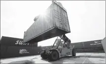  ?? XINHUA ?? A loader moves a China-Europe rail freight container in Minsk, Belarus, in 2018.