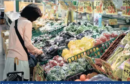  ?? PICTURE: AKIO KON/BLOOMBERG ?? A customer at an Akidai YK supermarke­t in Tokyo. Rising prices make consumers defensive about spending, so stronger wage gains are critical to acceptance of price increases, according to Japan’s central bank.