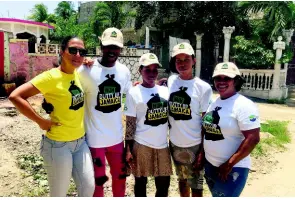  ??  ?? Residents of the Lakes Pen community pause for a photo with Suzanne Stanley (left), CEO of JET, during a Nuh Dutty Up Jamaica activity in 2017.