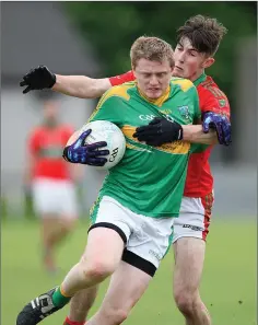  ??  ?? John Nolan of Laragh is challenged by Rathnew’s Gary Hughes.