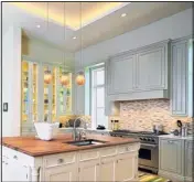  ?? COURTESY OF NORA LIGHTING/MCT ?? This kitchen uses ambient, task and accent lighting. Stylish pendants hang over the kitchen island for task lighting, while recessed ceiling fixtures provide ambient light. Under- and in-cabinet lights provide accent lighting.