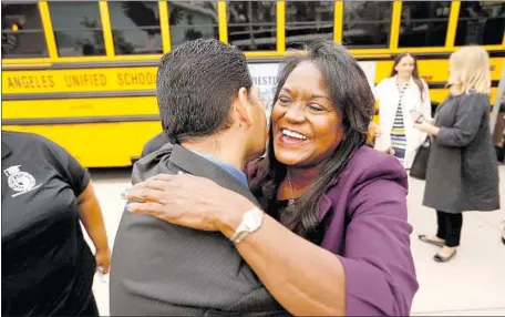  ?? Photograph­s by Al Seib Los Angeles Times ?? SUPT. MICHELLE KING hugs Richard Guillen, principal of Mountain View Elementary in Tujunga, on the first day of school in August.