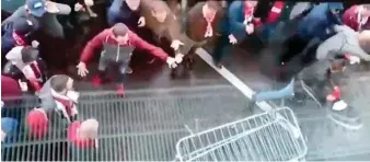  ??  ?? Rampage: German supporters try to force their way into the stadium