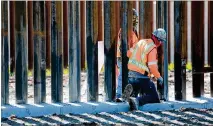  ?? SANDY HUFFAKER / GETTY IMAGES ?? Constructi­on workers build a secondary border wall Feb. 22 in Otay Mesa, California. The Department of Homeland Security is building 12.5 miles of secondary border wall.