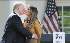  ?? Susan Walsh ?? The Associated Press President Donald Trump kisses first lady Melania Trump following a Rose Garden event Monday where the first lady announced her “Be Best” campaign.