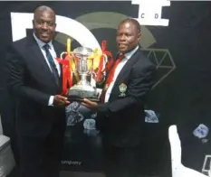  ??  ?? Eastern Region secretary Simba Wisdom (right) and ZCDC relations executive Sugar Chagonda holding the Diamond Super Cup trophy.