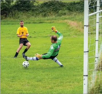  ??  ?? Jamie Kelly beats goalkeeper Owen English to score the first St Peter’s goal.