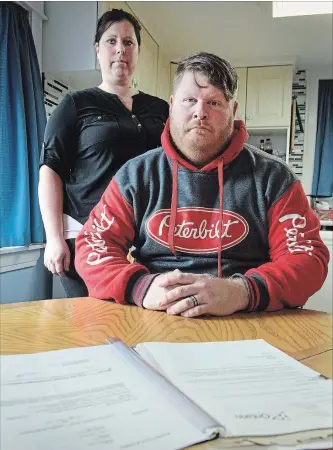  ?? SCOTT GARDNER THE HAMILTON SPECTATOR ?? Jennifer and Jon Bennett with some of the legal papers they have accumulate­d during the battle with a Waterdown gym over fees charged to the couple after they cancelled their membership.