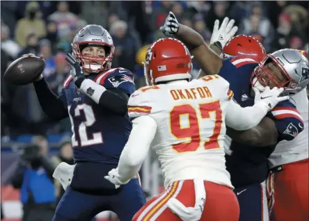  ?? STEVEN SENNE - THE ASSOCIATED PRESS ?? New England Patriots quarterbac­k Tom Brady (12) passes under pressure from Kansas City Chiefs defensive end Alex Okafor (97) in the first half of an NFL football game, Sunday, Dec. 8, 2019, in Foxborough, Mass.