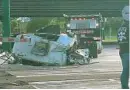  ?? CHUCK WEBER/WPEC-CH. 12 ?? A trash truck was severely damaged when it stalled on railroad tracks and was struck by a Tri-Rail train.