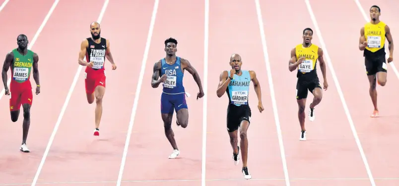  ?? AP ?? Steven Gardiner of The Bahamas (third right) strides to victory in the 400m at the World Athletics Championsh­ips in Doha, Qatar, on Friday. Others (from left) are Kirani James of Grenada, Machel Cedenio of Trinidad and Tobago, Fred Kerley of the United States, Demish Gaye of Jamaica, and Akeem Bloomfield, also of Jamaica. Gaye was fourth and his compatriot, Bloomfield, finished eighth.